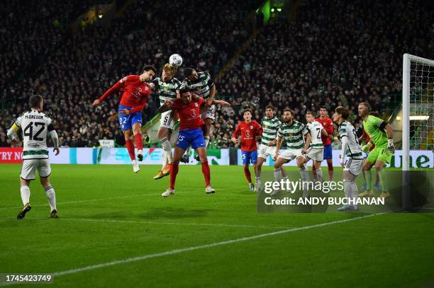 Atletico Madrid's Spanish defender Mario Hermoso and Celtic's Irish defender Liam Scales fight for the ball during the UEFA Champions League group E...