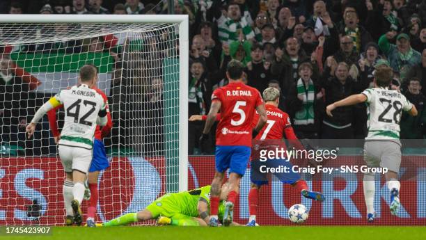 Atletico Madrid's Antoinne Griezmann scores the rebound to make it 1-1 after his penalty is saved during a UEFA Champions League match between Celtic...