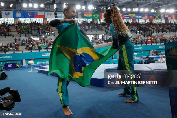 Brazil's Rebeca Andrade and Flavia Saraiva celebrate after winning the gold and silver medals respectively in the artistic gymnastics women's balance...