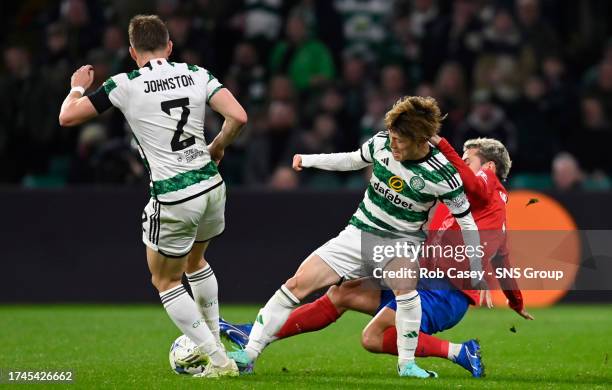 Celti's Kyogo Furuhashi is tackled by Atletico Madrid's Antoinne Griezmann during a UEFA Champions League match between Celtic and Atletico de Madrid...