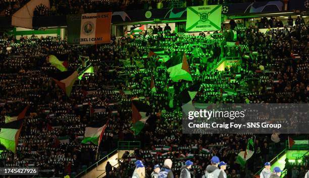 Celtic fans hold up Palestine flags during a UEFA Champions League match between Celtic and Atletico de Madrid at Celtic Park, on October 25 in...