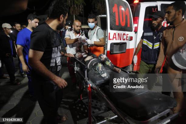Injured Palestinian people are taken to the Al Aqsa Martyrs Hospital after Israeli attacks with warplanes and artillery fire as Israeli attacks...