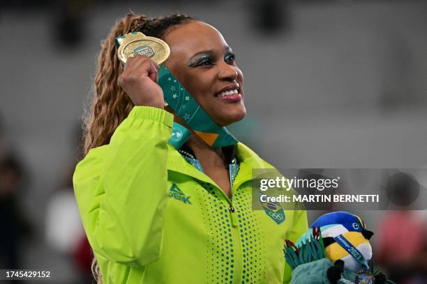 Brazil's Rebeca Andrade poses on the podium with her gold medal after the artistic gymnastics women's balance beam final during the Pan American...