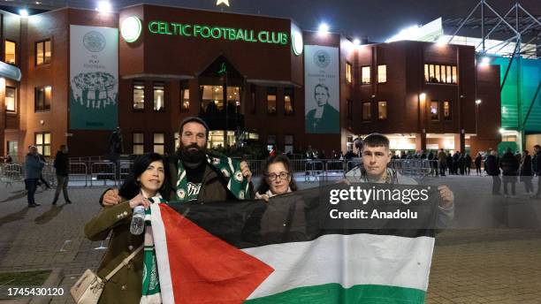 Supporters hold Palestinian flags at the end of the UEFA Champions League group E football match between Celtic and Atletico Madrid at Celtic Park...