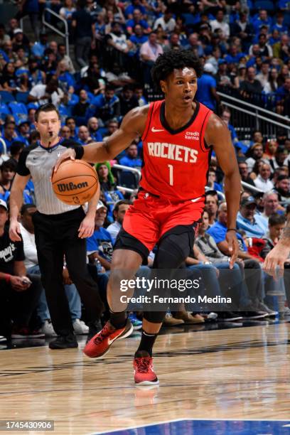 Amen Thompson of the Houston Rockets dribbles the ball during the game against the Orlando Magic on October 25, 2023 at Amway Center in Orlando,...