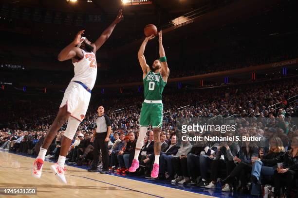 Jayson Tatum of the Boston Celtics shoots a three point basket against the New York Knicks on October 25, 2023 at Madison Square Garden in New York...