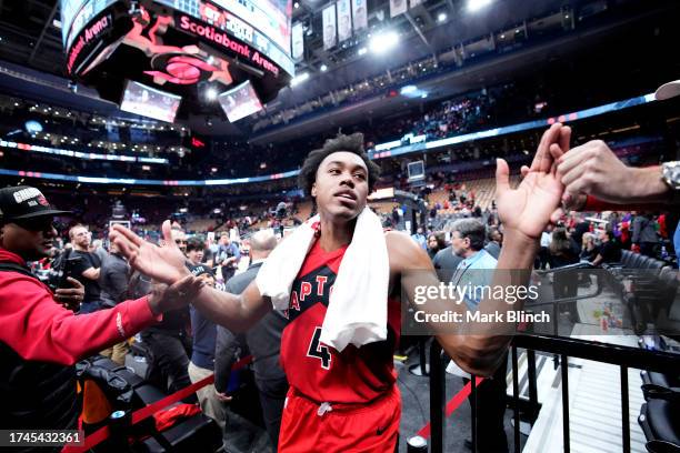 Scottie Barnes of the Toronto Raptors high fives after the game against the Minnesota Timberwolves on October 25, 2023 at the Scotiabank Arena in...