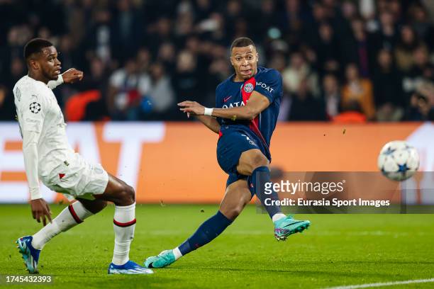 Kylian Mbappe of Paris Saint Germain attempts a kick while being defended by Pierre Kalulu of AC Milan during the UEFA Champions League Group Stage...