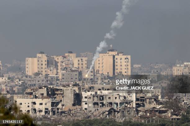Picture taken from the southern Israeli city of Sderot on October 26, 2023 shows flares fired by the Israeli army over the northern Gaza Strip, amid...