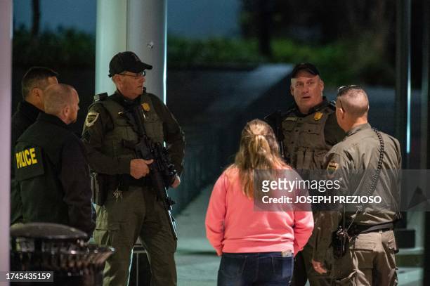 Armed law enforcement officials guard the ambulance entrance to the Central Maine Medical Center in Lewiston, Maine early on October 26, 2023. A...