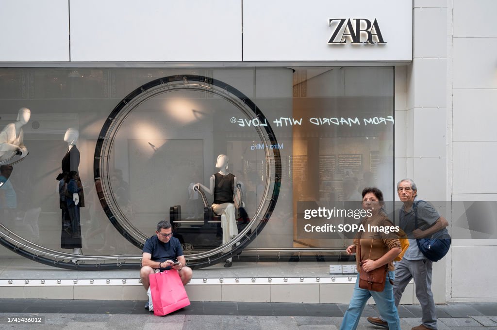 Shoppers are seen in front of the Spanish multinational...