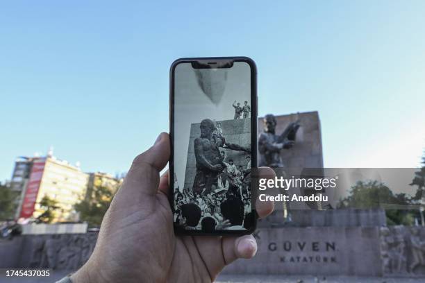 Man holds a phone showing Anadolu Agency's archive photo from 1989 of citizens celebrating Fenerbahce's championship, in Ankara, Turkiye on October...