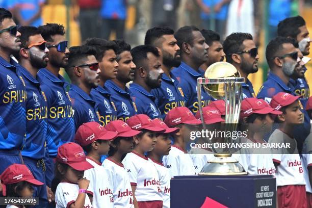 Sri Lanka's players stand for their national anthem before the start of the 2023 ICC Men's Cricket World Cup one-day international match between...