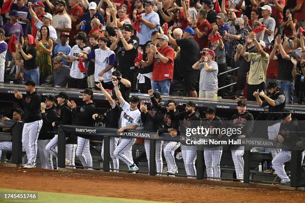 The Arizona Diamondbacks celebrate an infield single hit by Pavin Smith against the Philadelphia Phillies during the ninth inning in Game Three of...