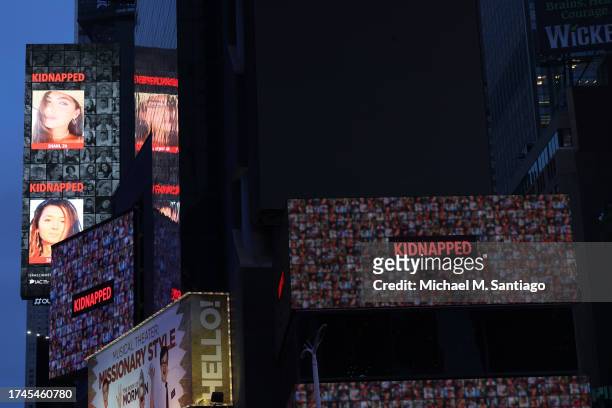 The images of hostages held by Hamas in Gaza are displayed on a billboard at a rally in Times Square on October 19, 2023 in New York City. Family...