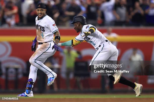 Ketel Marte of the Arizona Diamondbacks celebrates with Geraldo Perdomo after hitting an RBI single against Craig Kimbrel of the Philadelphia...