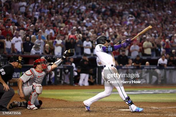 Ketel Marte of the Arizona Diamondbacks hits an RBI single against Craig Kimbrel of the Philadelphia Phillies to win Game Three of the National...