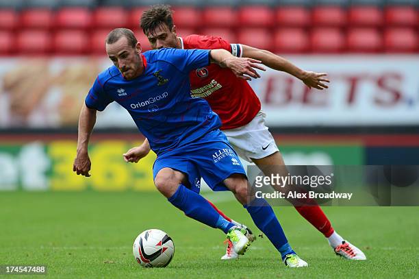 Johnnie Jackson of Charlton Athletic and James Vincent of Inverness contest the ball during the Pre Season Friendly match between Charlton Athletic...