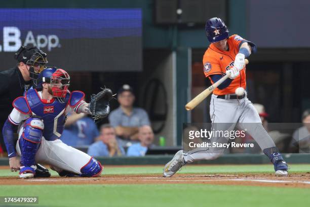 Alex Bregman of the Houston Astros hits a triple in the first inning against the Texas Rangers during Game Four of the Championship Series at Globe...
