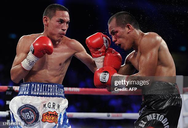 Philippines' Milan Melindo competes with Mexico's Juan Francisco Estrada during a WBO WBA flyweight title fight bout in Macau on July 27, 2013....