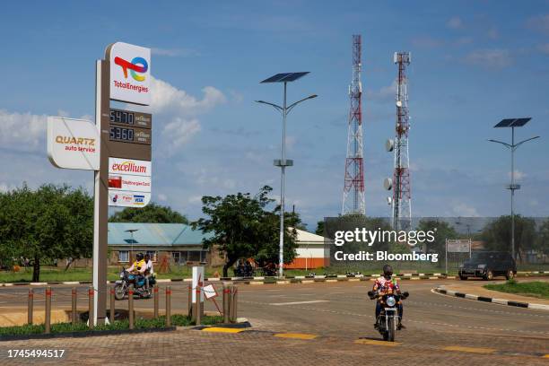 Solar-powered street lighting opposite signage for a TotalEnergies SE fuel station in Buliisa, Uganda, on Wednesday, Oct. 25, 2023. The $4 billion...