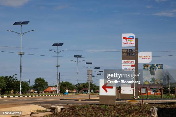 Solar-powered street lighting opposite signage for a TotalEnergies SE fuel station in Buliisa, Uganda, on Wednesday, Oct. 25, 2023. The $4 billion...