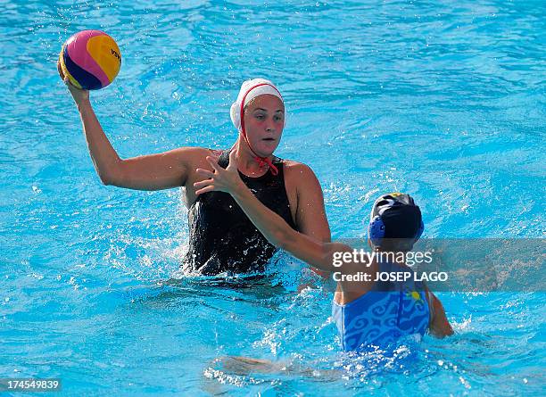 Canada's Monica Eggens is held back by Kazakhstan's Anna Zubkova during the preliminary rounds of the women's water polo at the FINA World...