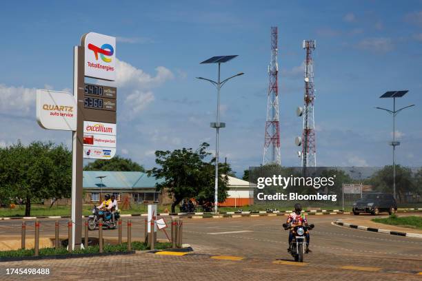 Solar-powered street lighting opposite signage for a TotalEnergies SE fuel station in Buliisa, Uganda, on Wednesday, Oct. 25, 2023. The $4 billion...