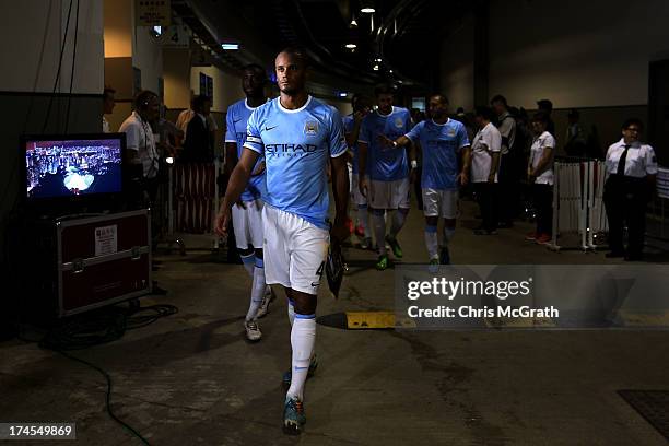 Vincent Kompany of Manchester City leads his team out to the pitch for the second half of the Barclays Asia Trophy Final match between Manchester...
