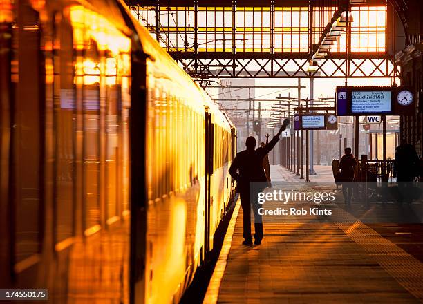 train conductor gives ready for departure signal - railway station platform stock pictures, royalty-free photos & images
