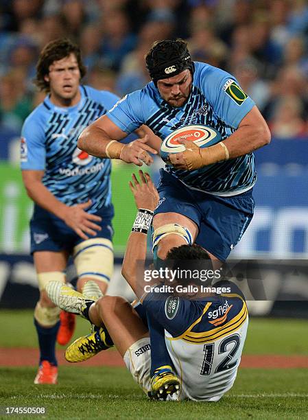 Flip van der Merwe of the Bulls is tackled by Christian Lealifano of Brumbies during the SupeRugby semi final match between Vodacom Bulls and...