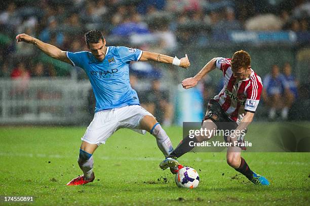 Alvaro Negredo of Machester City and Jack Colback of Sunderland compete for the ball during the Barclays Asia Trophy Final match between Manchester...