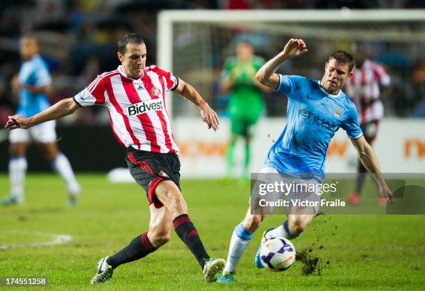 El-John O'Shea of Sunderland and James Milner of Manchester City fight for the ball during the Barclays Asia Trophy Final match between Manchester...