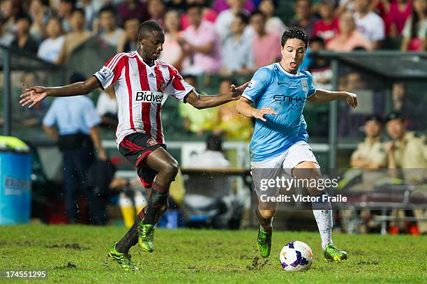 El-Hadji Ba of Sunderland and Samir Nasri of Manchester City fight for the ball during the Barclays Asia Trophy Final match between Manchester City...