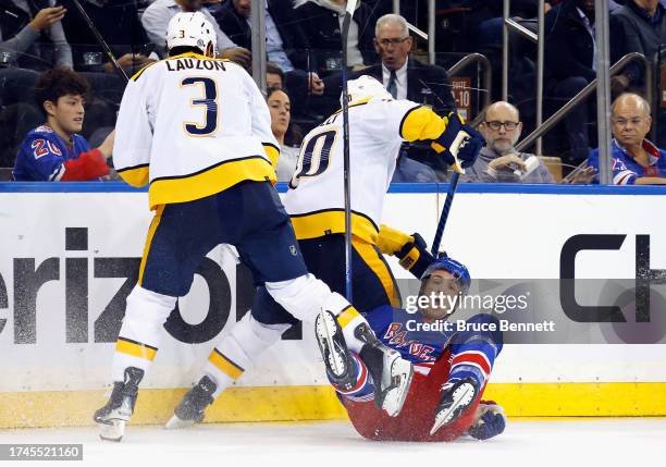 Jeremy Lauzon of the Nashville Predators checks Will Cuylle of the New York Rangers during the second period at Madison Square Garden on October 19,...