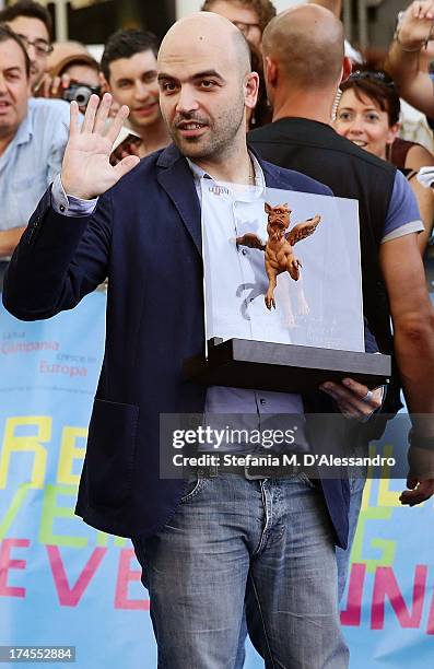 Roberto Saviano poses with the Truffaut Award at 2013 Giffoni Film Festival on July 27, 2013 in Giffoni Valle Piana, Italy.