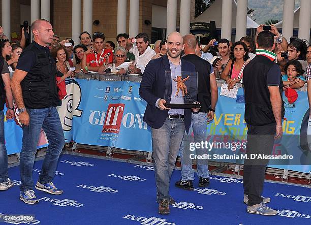 Roberto Saviano poses with the Truffaut Award at 2013 Giffoni Film Festival on July 27, 2013 in Giffoni Valle Piana, Italy.