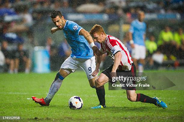 Alvaro Negredo of Machester City and Jack Colback of Sunderland fight for the ball during the Barclays Asia Trophy Final match between Manchester...