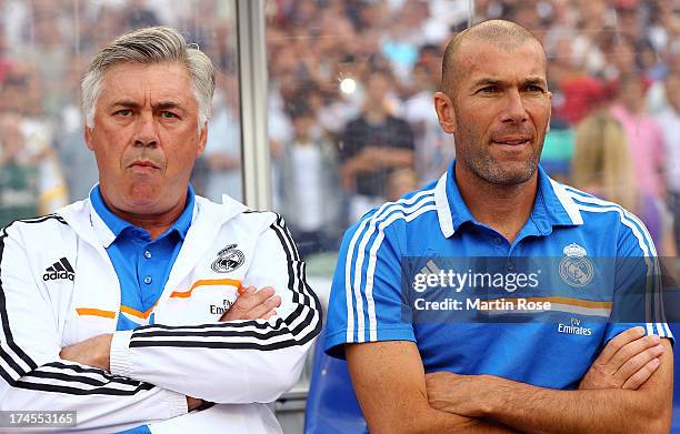 Carlo Ancelotti , head coach of Real Madrid and assistant coach Zinedine Zidane look on before the pre season friendly match between Real Madrid and...