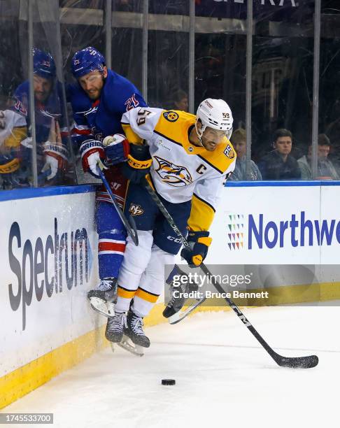 Roman Josi of the Nashville Predators checks Barclay Goodrow of the New York Rangers during the second period at Madison Square Garden on October 19,...