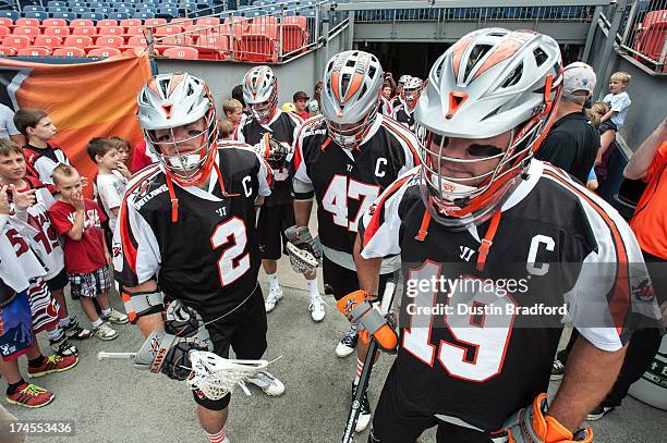 Denver Outlaws captains, from left, Brendan Mundorf, Anthony Kelly, and Jesse Schwartzman prepare to run out on the field before a game against the...