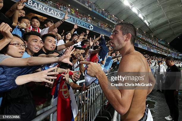 Aleksandar Kolarov of manchester City jokes with fans before giving away his jersey after the Barclays Asia Trophy Final match between Manchester...