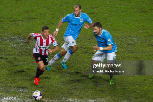 El-Emanuele Giaccherini of Sunderland and Javi Garcia of Manchester City fight for the ball during the Barclays Asia Trophy Final match between...