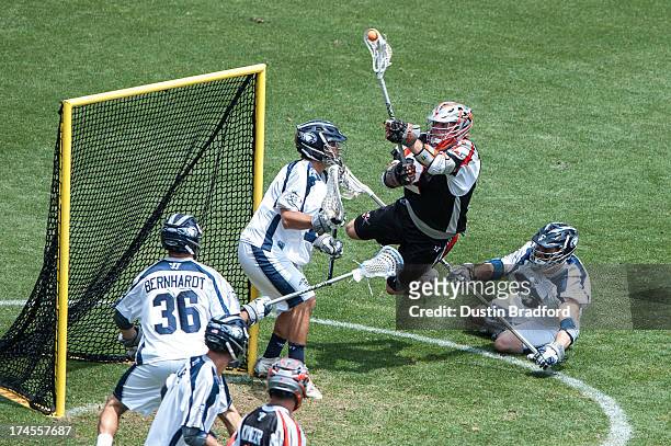 Brendan Mundorf of the Denver Outlaws makes a point-blank diving attempt to get the ball past Kip Turner of the Chesapeake Bayhawks during a Major...