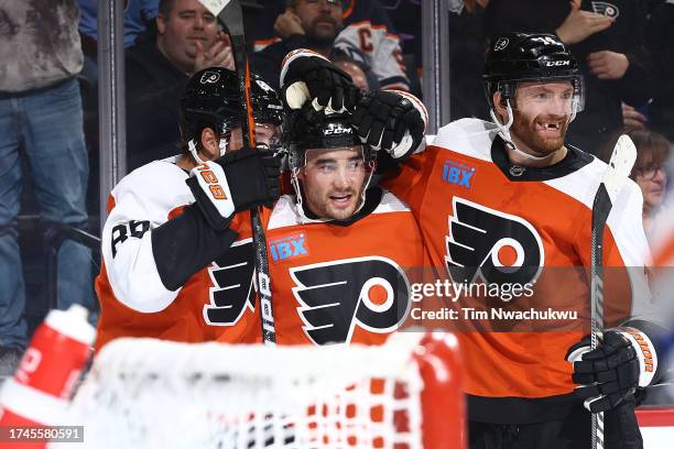 Nick Seeler, Sean Walker and Sean Couturier of the Philadelphia Flyers react following a goal by Walker during the second period against the Edmonton...