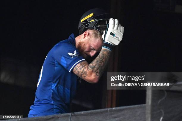 England's Ben Stokes walks back to the dressing-room after his dismissal during the 2023 ICC Men's Cricket World Cup one-day international match...