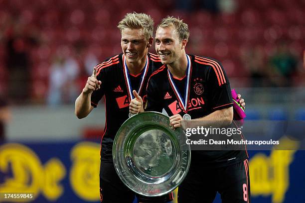 Viktor Fischer and Christian Eriksen of Ajax pose with the trophy after victory in the Johan Cruyff Shield match between AZ Alkmaar and Ajax...