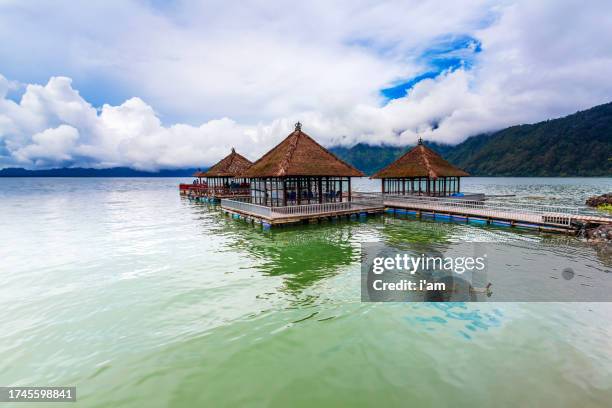 sunny day over floating restaurant at lake batur kintamani, bali, indonesia - spotted lake stock pictures, royalty-free photos & images