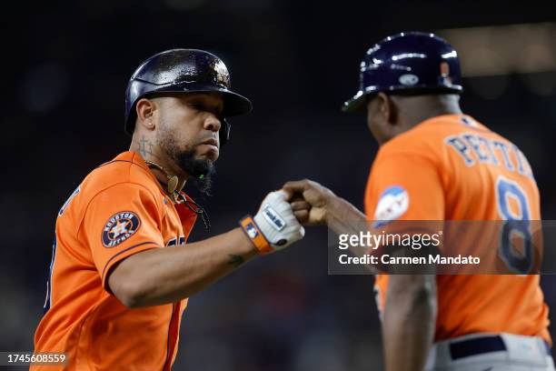 José Abreu and third base coach Gary Pettis of the Houston Astros celebrate after Abreu hit a home run in the fourth inning against the Texas Rangers...