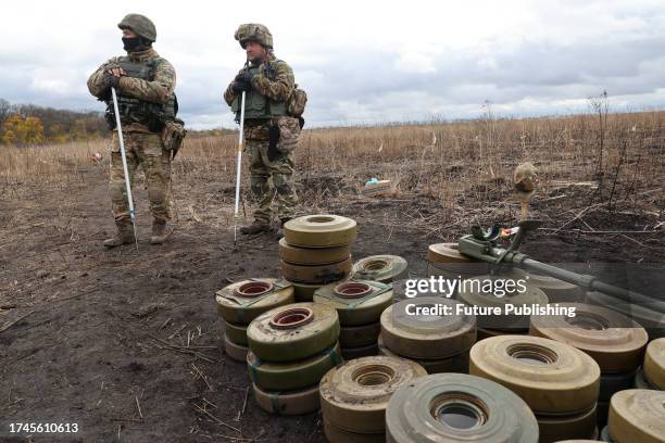 Experts of a consolidated squad of the Explosives Service of Ukraine carry out demining works in Kharkiv Region, northeastern Ukraine.